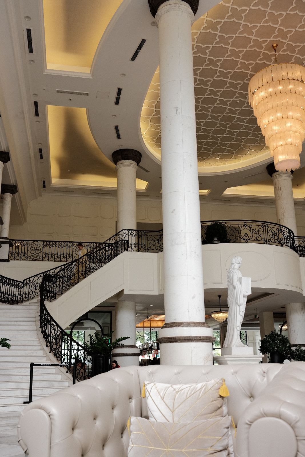 Main lobby with a curved double staircase and chandelier